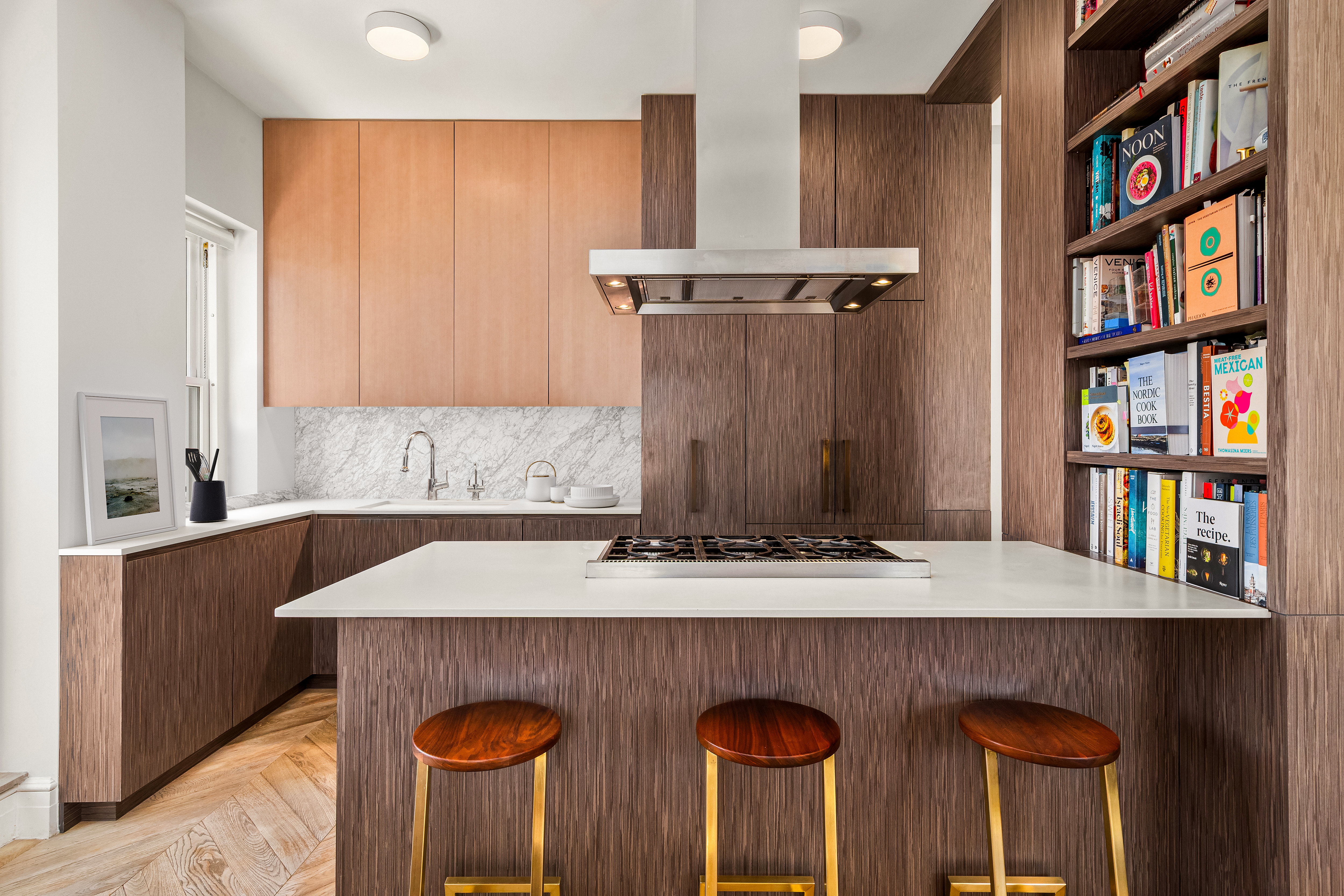 243 West End Avenue, Unit PH Manhattan, NY 10023 - Photo 3 of 11 a kitchen with stainless steel appliances granite countertop a table chairs and cabinets