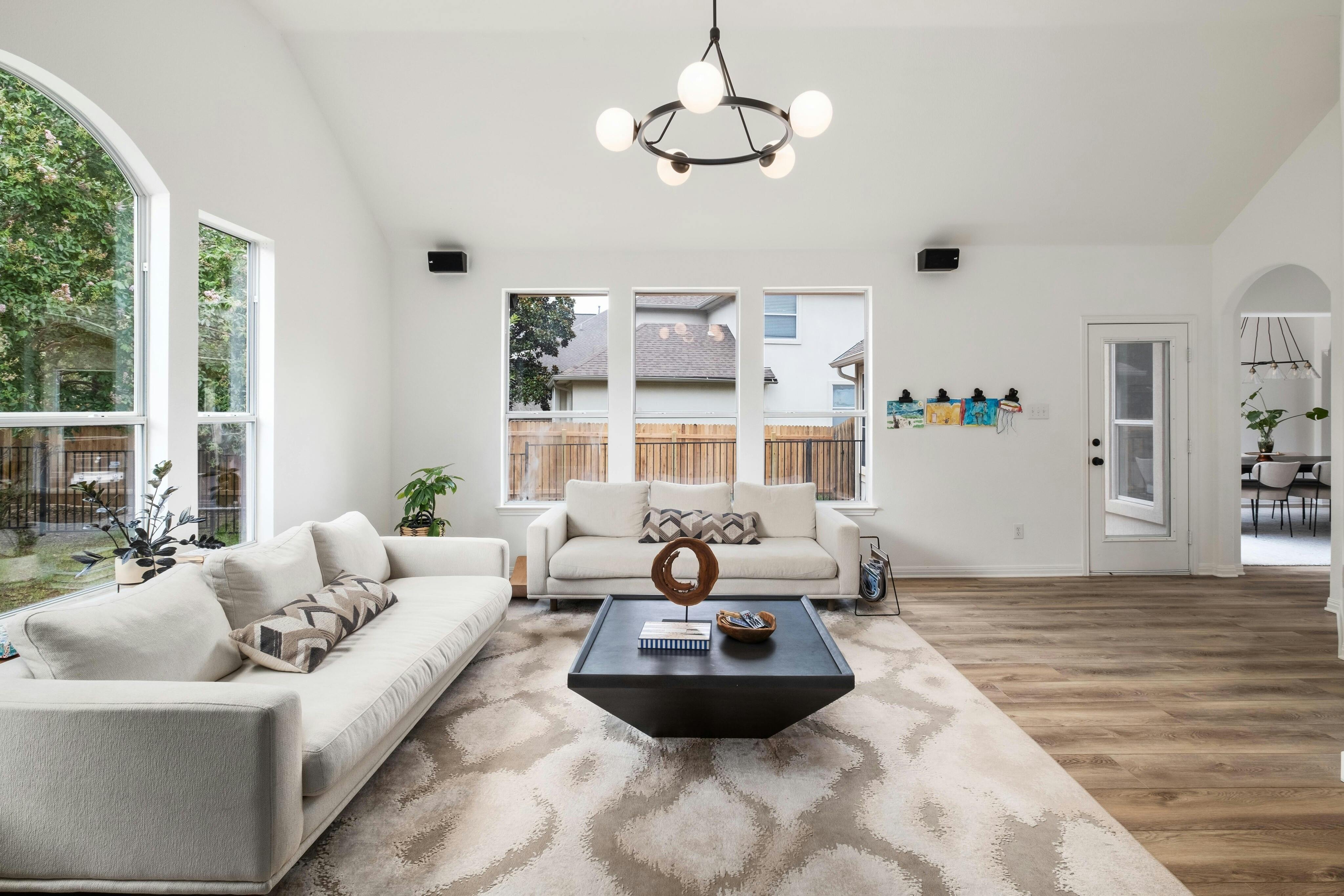 10608 Pointe View Drive Austin, TX 78738 - Photo 12 of 46 a living room with furniture chandelier and a large window