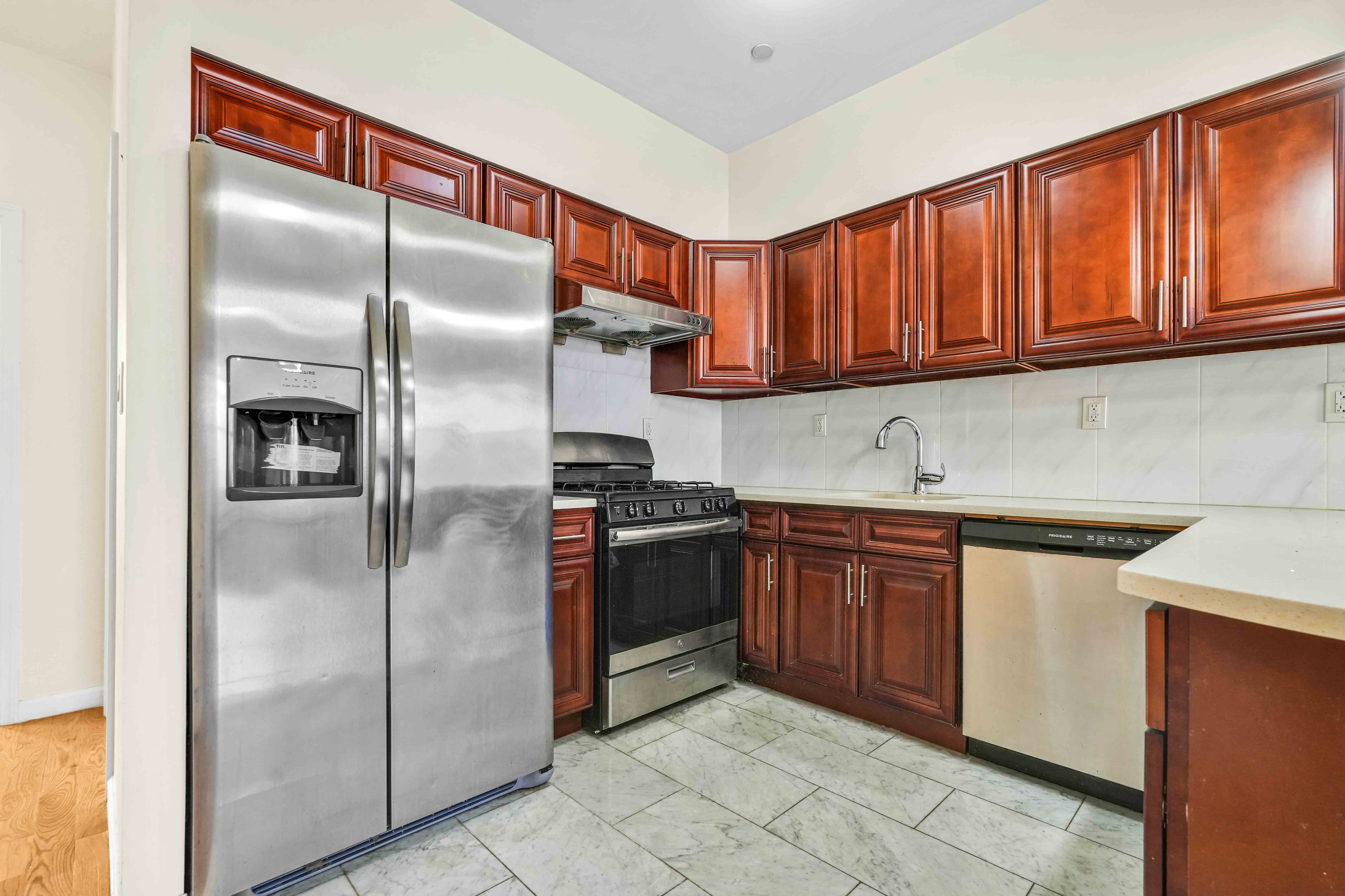 1892 Bergen Street, Unit 2 Brooklyn, NY 11233 - Photo 17 of 24 a kitchen with stainless steel appliances granite countertop a refrigerator a sink and dishwasher