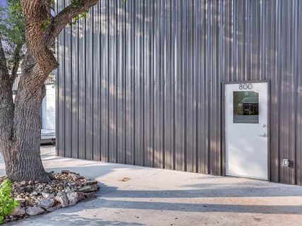 a view of backyard with tub and trees in the background