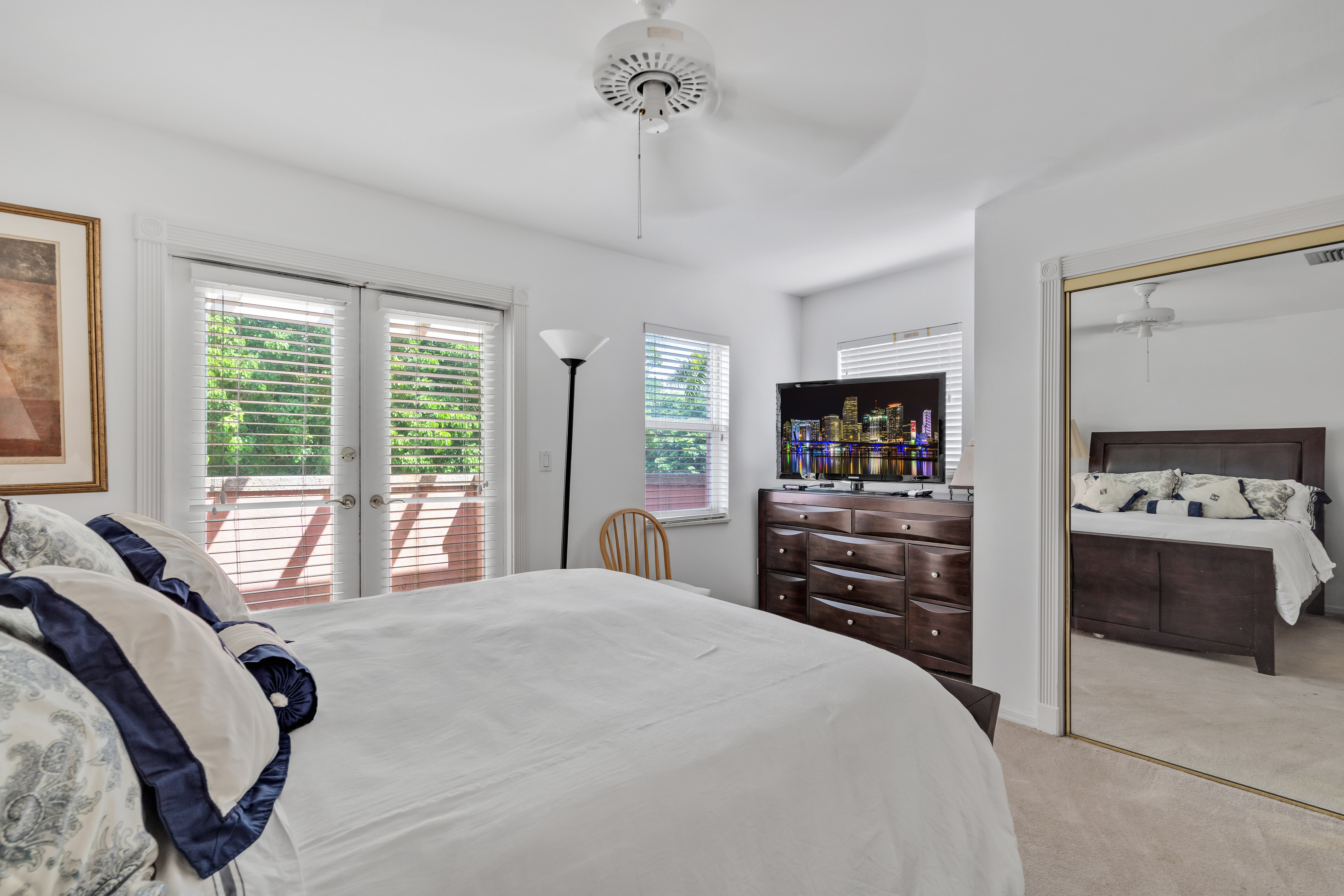 8768 Southwest 62nd Court Miami, FL 33156 - Photo 34 of 56 a bedroom with a large bed and a flat tv screen