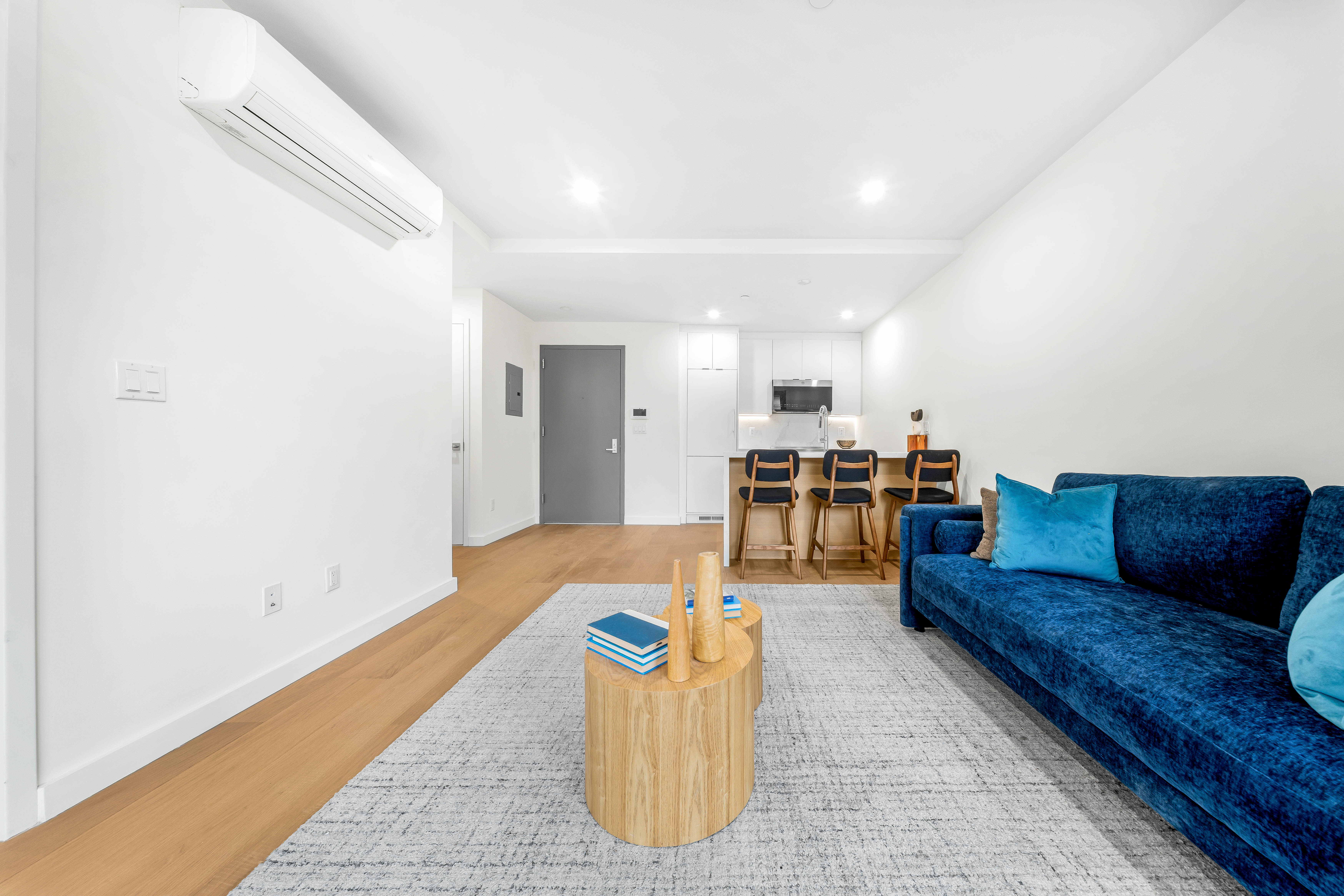 30-24 32nd Street, Unit 3A Queens, NY 11102 - Photo 3 of 18 a living room with furniture and kitchen view