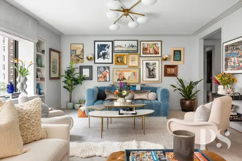 a living room with furniture potted plant and window