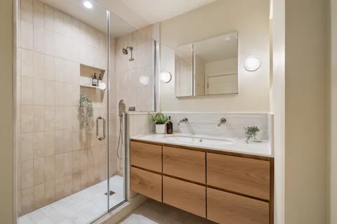 a bathroom with a granite countertop sink mirror and double