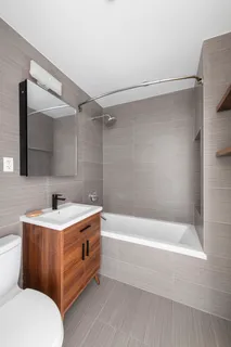 a bathroom with a sink a mirror and a bathtub