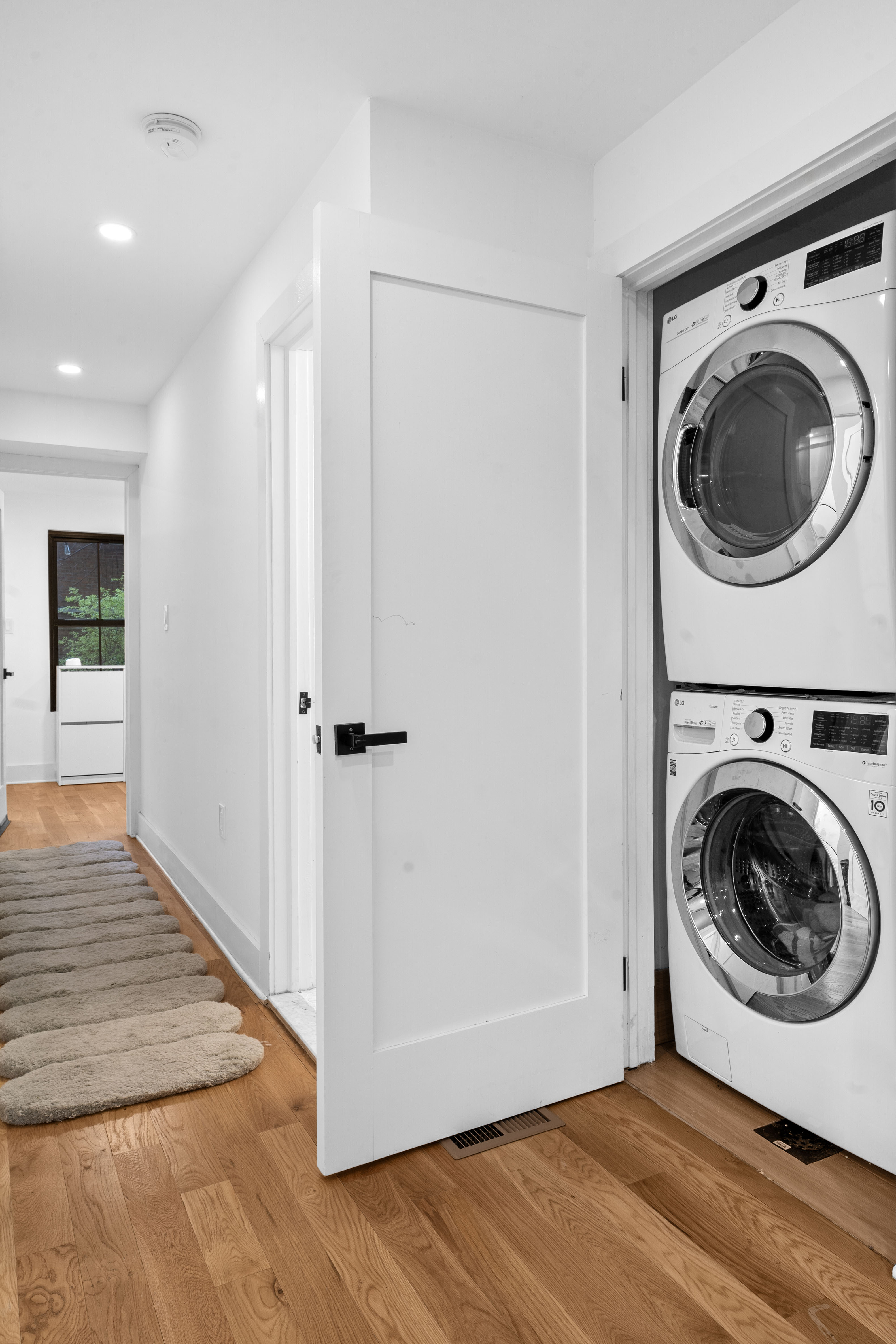 1591 Pacific Street Brooklyn, NY 11213 - Photo 14 of 16 a view of a hallway with washer and dryer