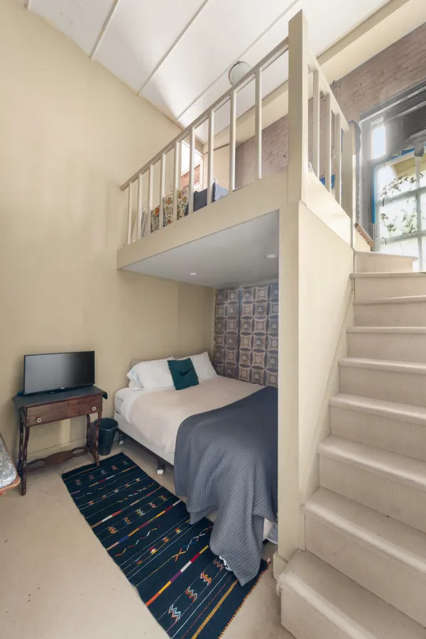 a bedroom with furniture and a window
