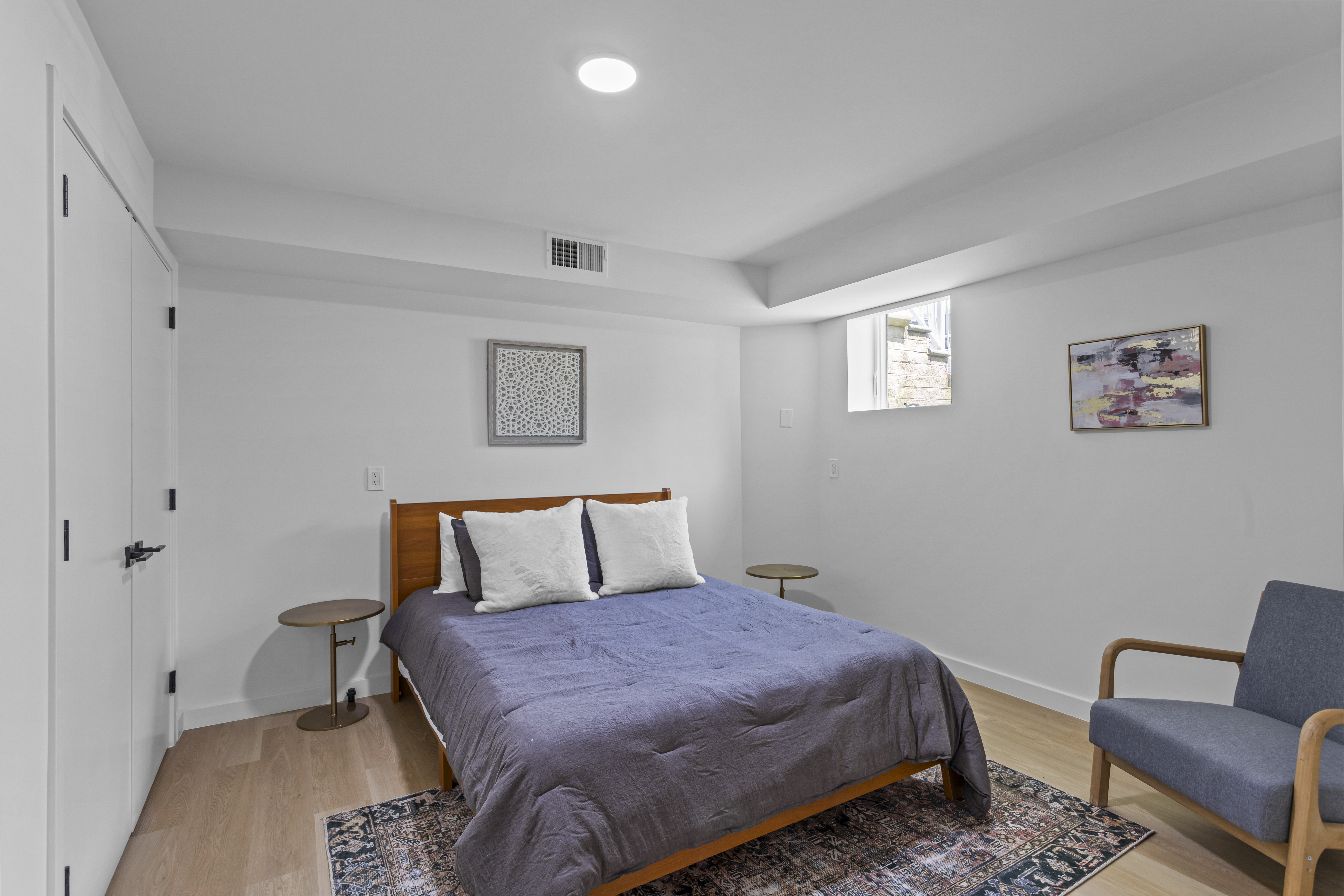 3112 Emmons Avenue, Unit 3124A2 Brooklyn, NY 11235 - Photo 10 of 17 a bedroom with a bed and a couch