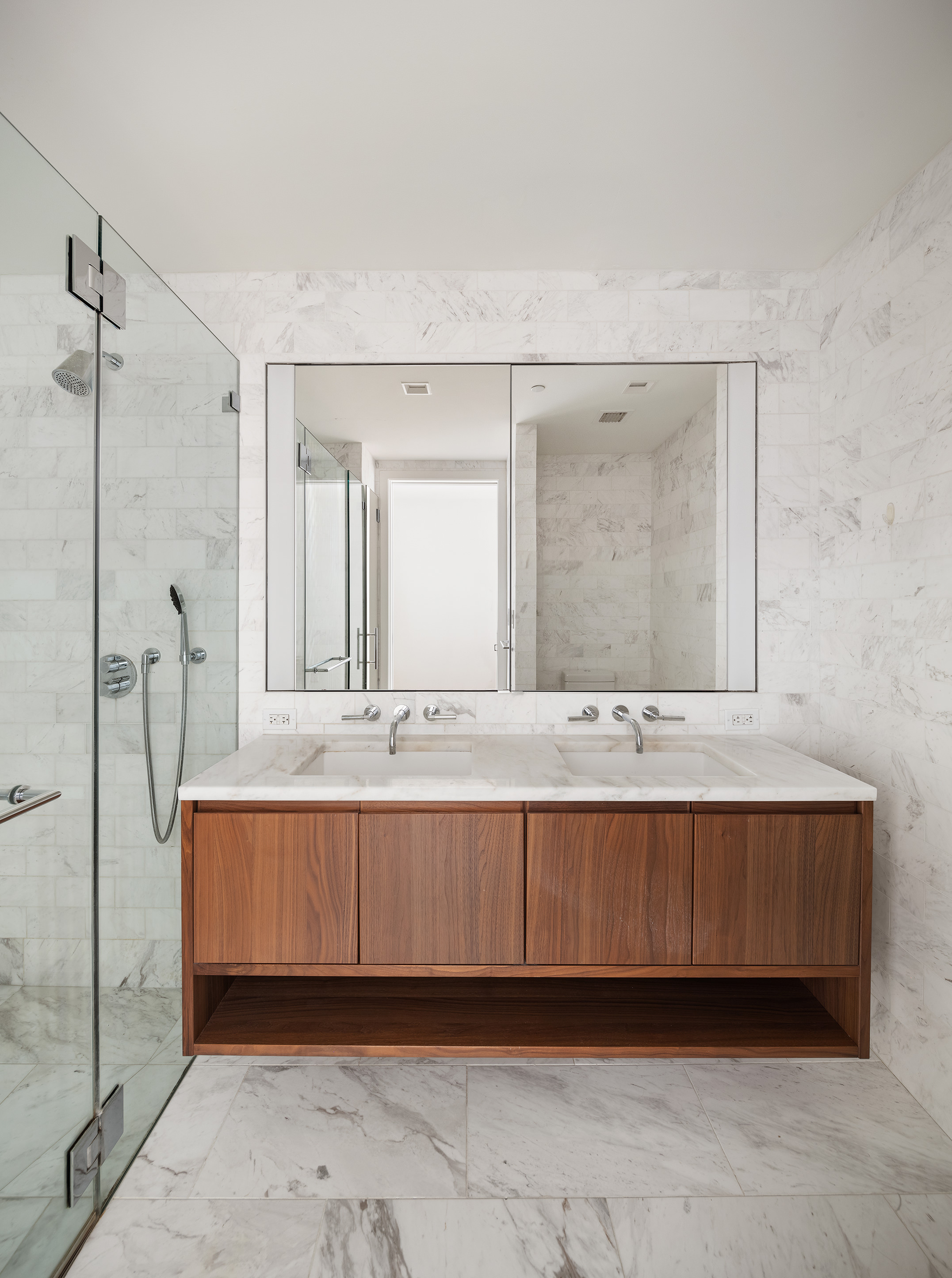 242 Broome Street, Unit 7C Manhattan, NY 10002 - Photo 4 of 7 a bathroom with a double vanity sink and a mirror