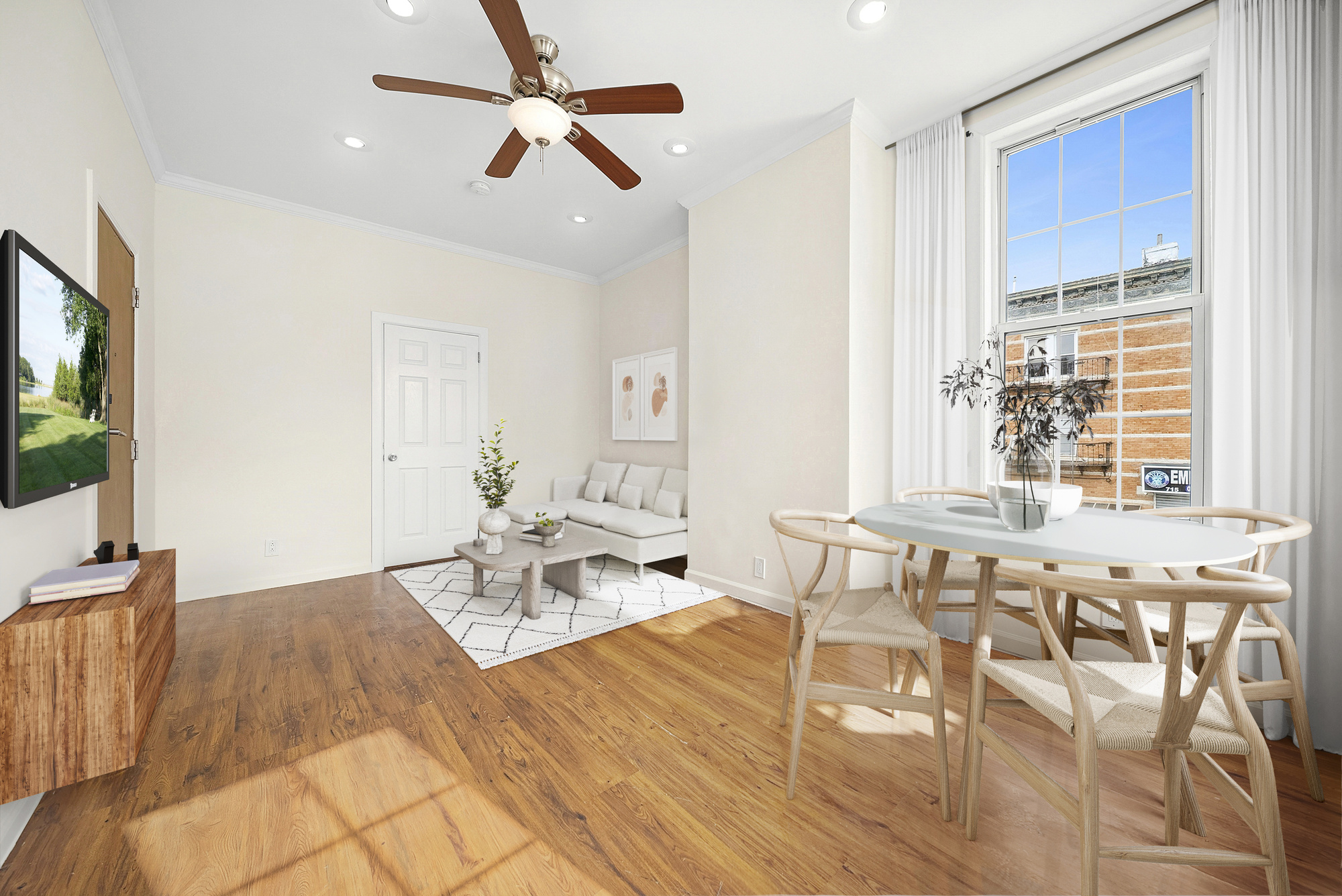 109 Moffat Street, Unit 2F Brooklyn, NY 11207 - Photo 2 of 8 a living room with furniture a flat screen tv and a window