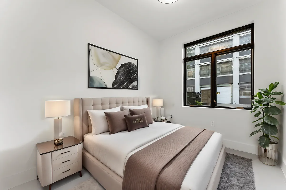 30 Belvidere Street, Unit 1B Brooklyn, NY 11206 - Photo 4 of 6 a bedroom with bed and a potted plant
