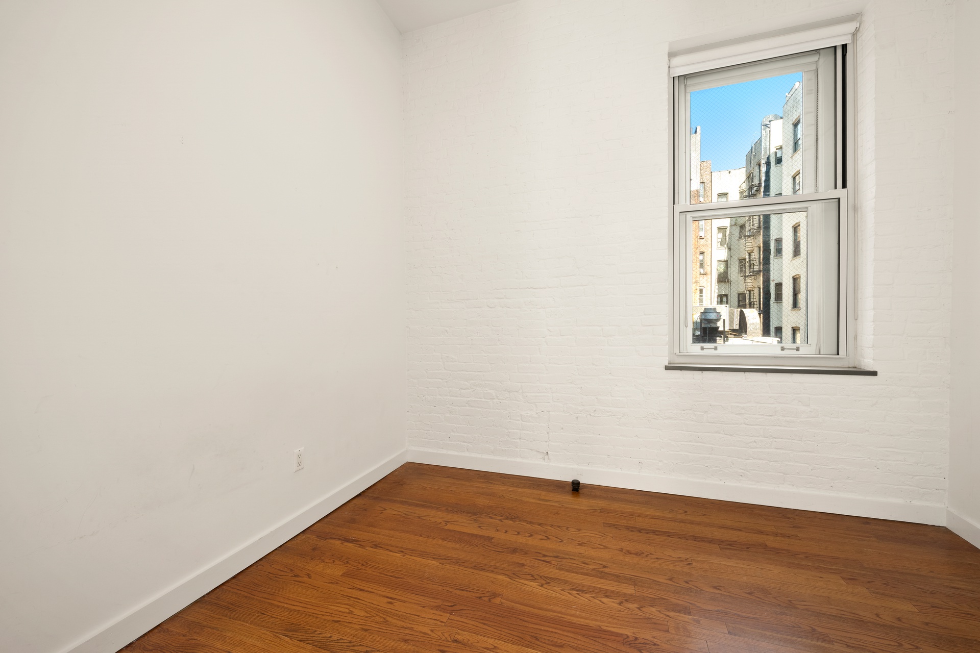 520 LaGuardia Place, Unit 2N Manhattan, NY 10012 - Photo 16 of 20 a view of a small space with wooden floor and a window