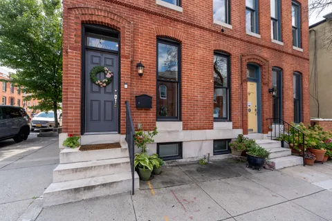 a front view of a building with potted plants