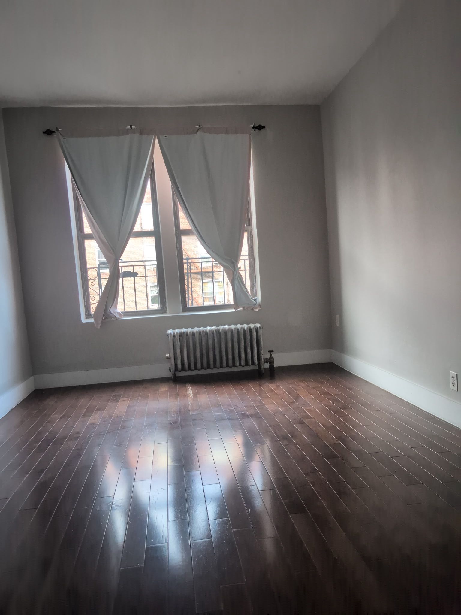 2405 Nostrand Avenue, Unit 6 Brooklyn, NY 11210 - Photo 4 of 11 an empty room with wooden floor and windows