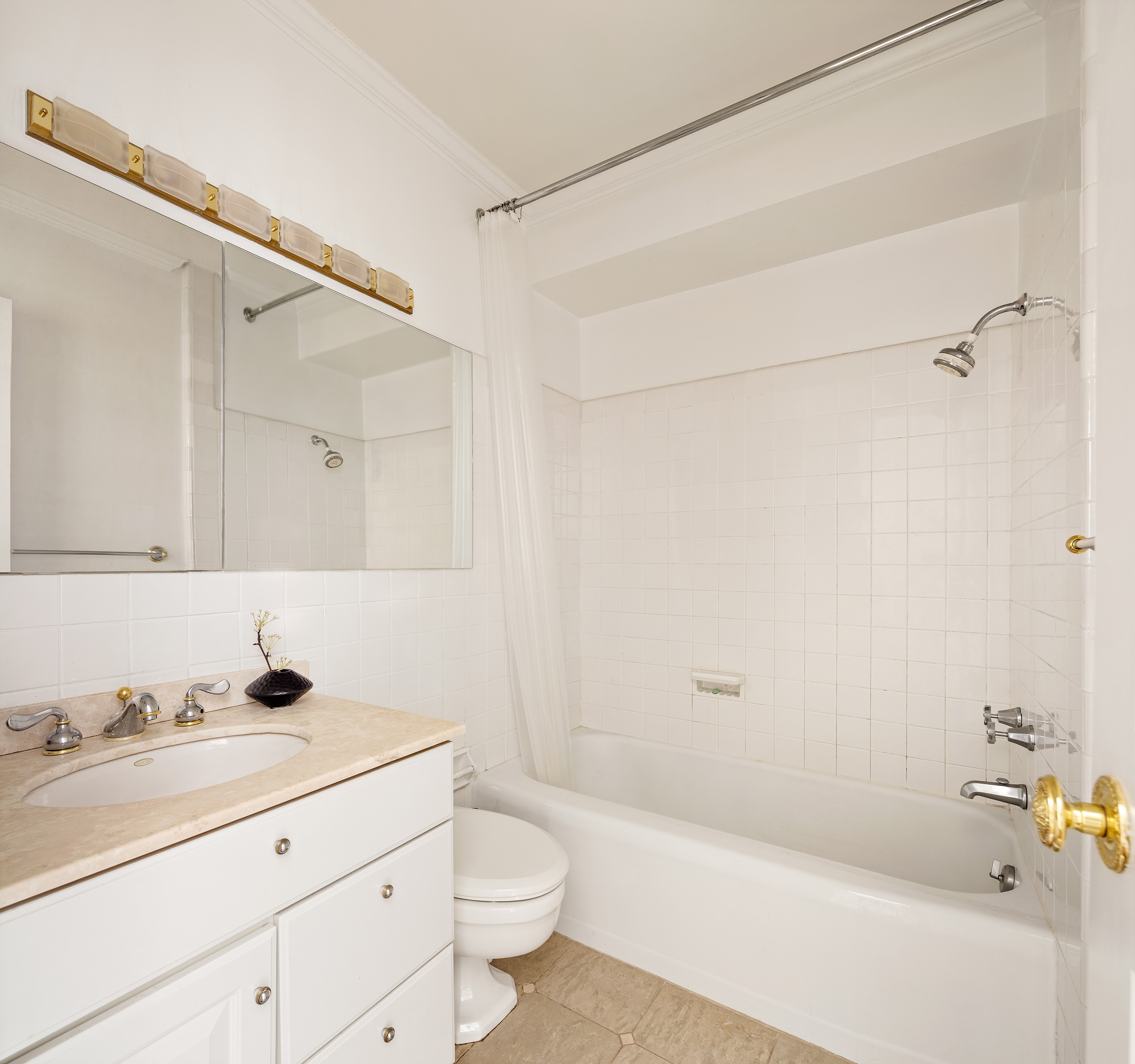 12 Beekman Place, Unit 7/8B Manhattan, NY 10022 - Photo 10 of 17 a bathroom with a bathtub shower sink vanity and toilet