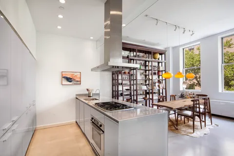 a kitchen with stainless steel appliances granite countertop a stove and a refrigerator