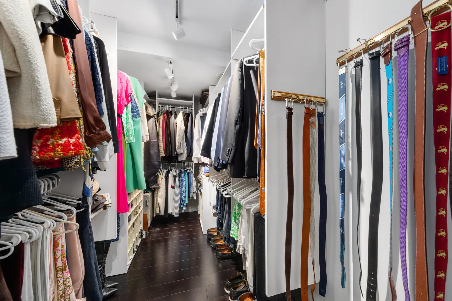 a view of walk in closet with clothes