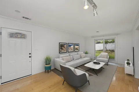 a living room with furniture rug and window