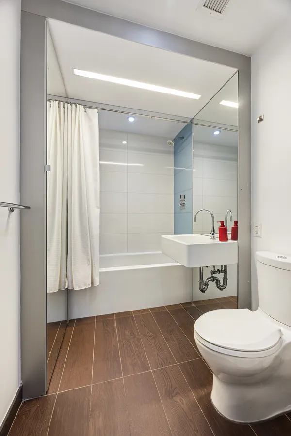 a bathroom with a toilet and a shower