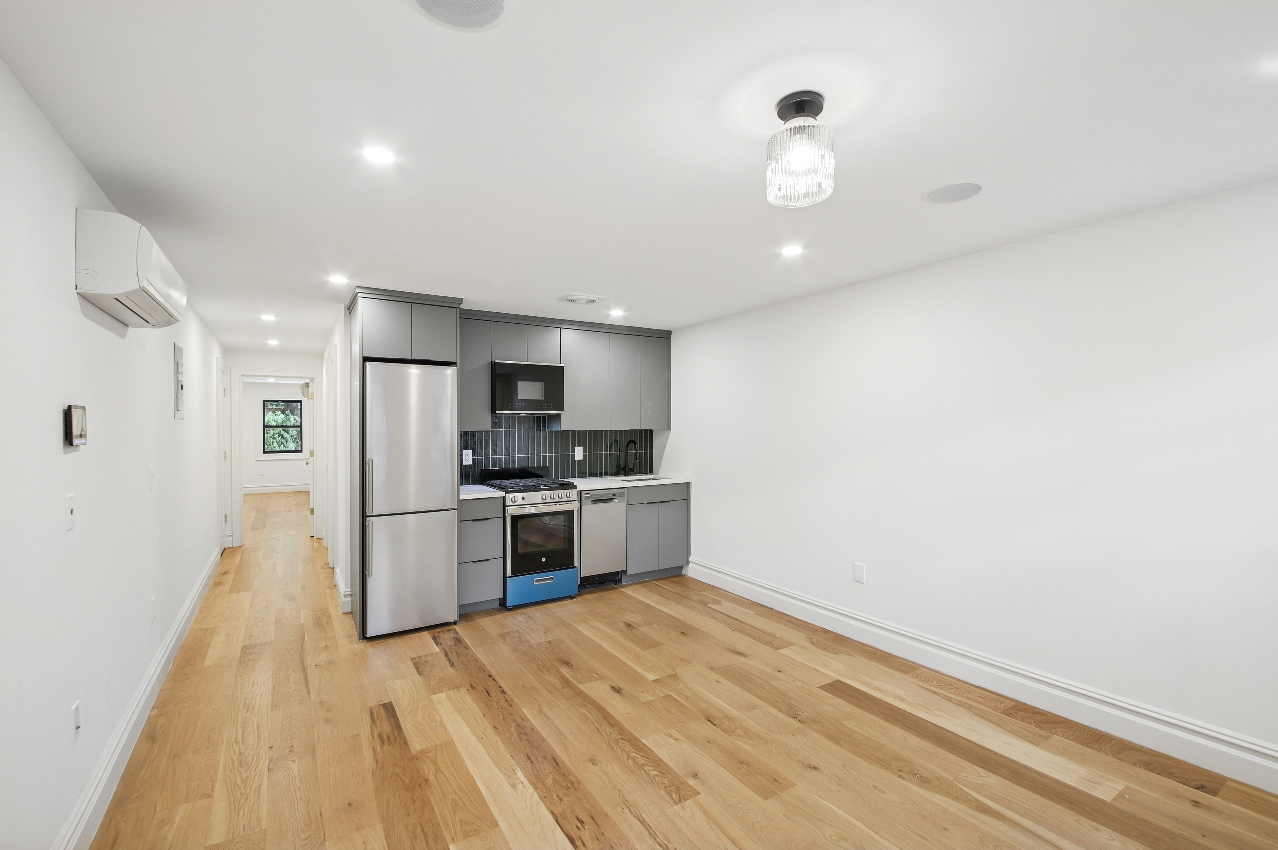 a kitchen with stainless steel appliances a refrigerator and a stove top oven