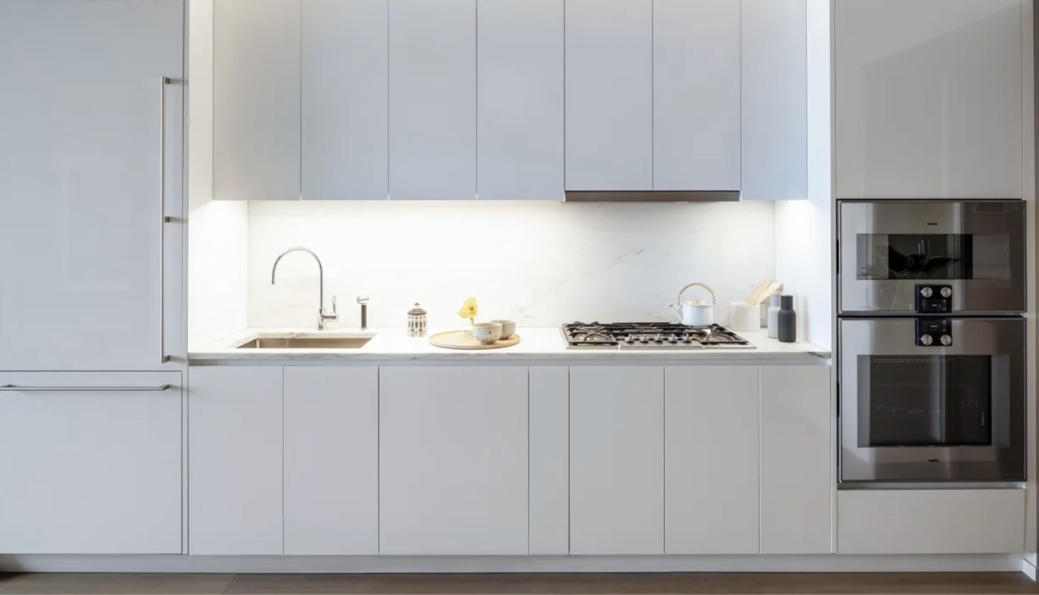 695 1st Avenue, Unit 31C Manhattan, NY 10016 - Photo 5 of 27 a kitchen with cabinets and white appliances