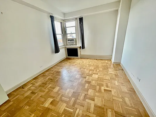 900 West 190th Street, Unit 9B Manhattan, NY 10040 - Photo 12 of 16 a view of an empty room and window