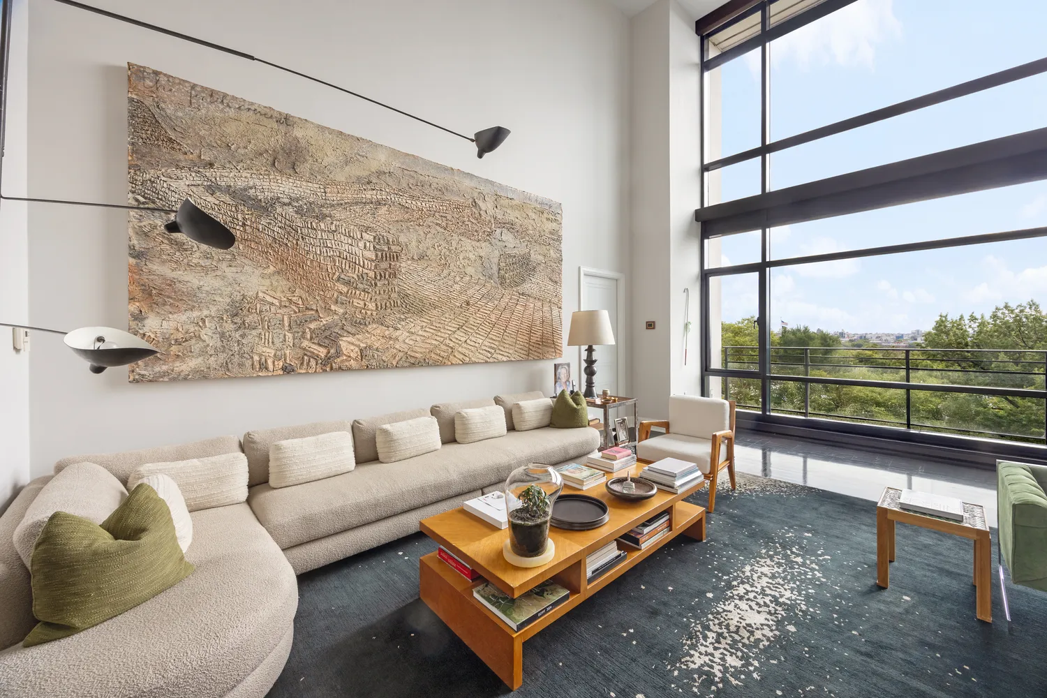 a living room with furniture and a floor to ceiling window