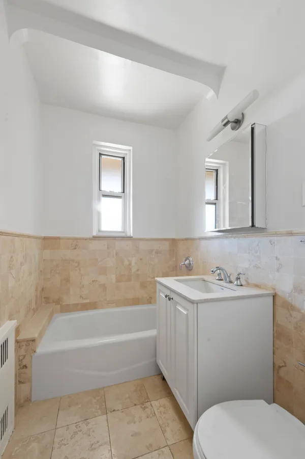 a bathroom with a sink a toilet and mirror