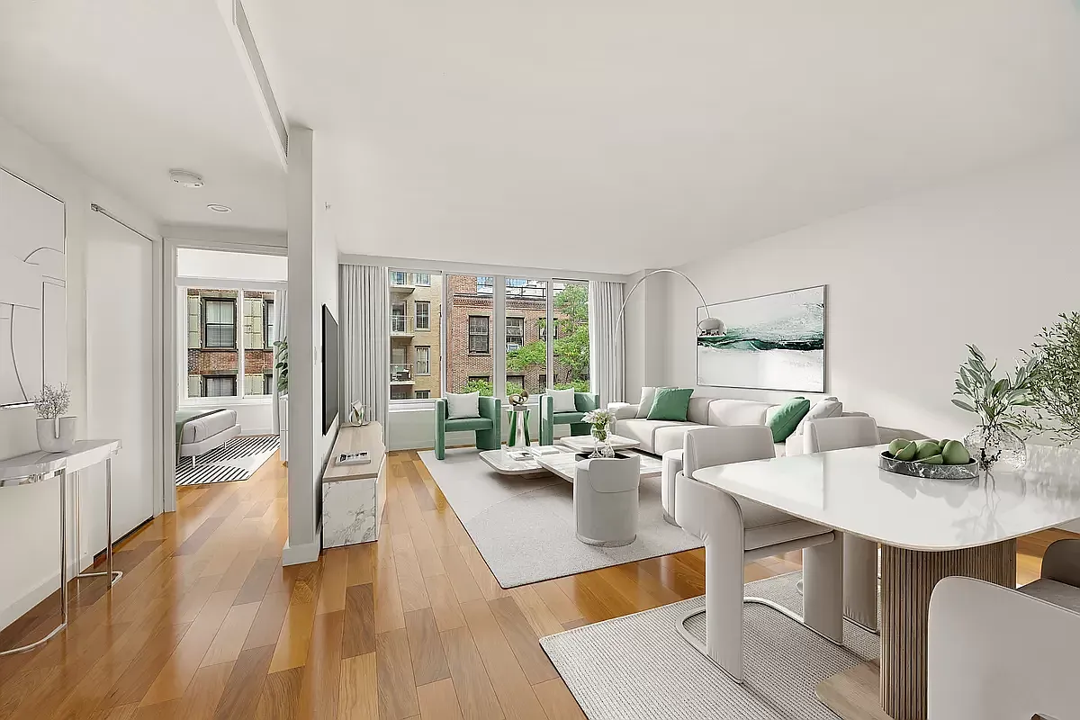 a living room with furniture a large window and wooden floor