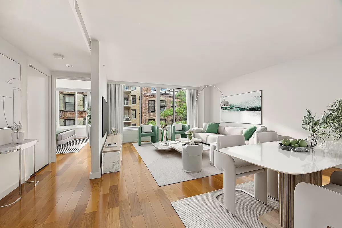 a living room with furniture a large window and wooden floor
