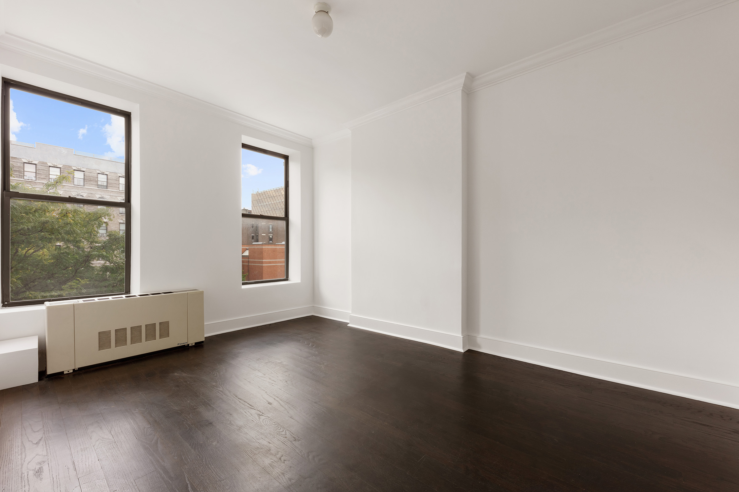 555 Lenox Avenue, Unit 3F Manhattan, NY 10030 - Photo 9 of 10 a view of an empty room with wooden floor and a window