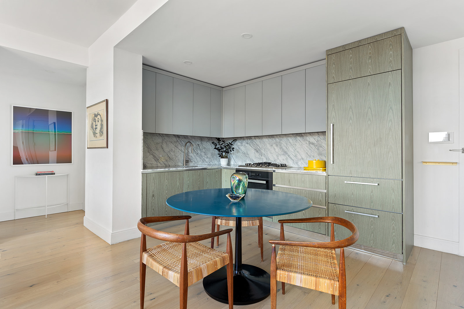 229 9th Street, Unit 601 Brooklyn, NY 11215 - Photo 5 of 13 a kitchen with stainless steel appliances a dining table and chairs