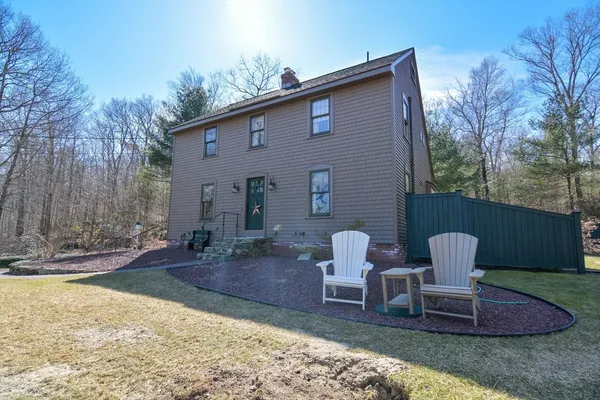 a brick house with table and chairs in front of it