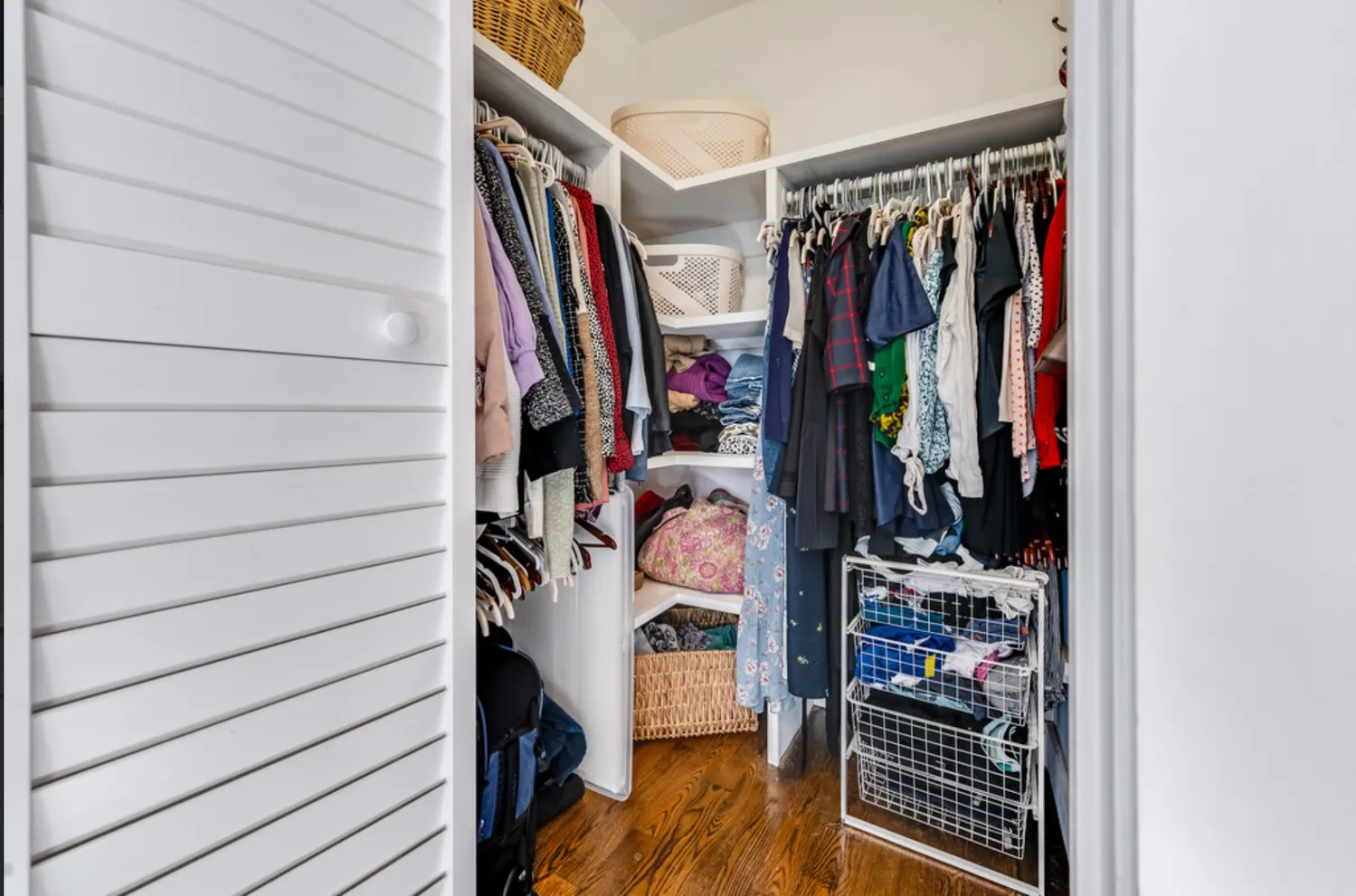 a view of walk in closet with clothes and shoes