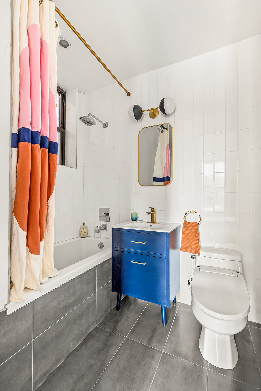 1153 Pacific Street, Unit 1 Brooklyn, NY 11216 - Photo 7 of 11 a bathroom with a toilet sink and mirror