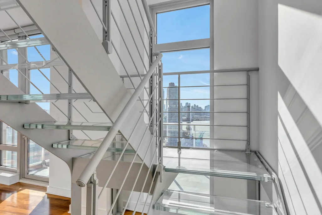 a view of staircase with white walls and a window