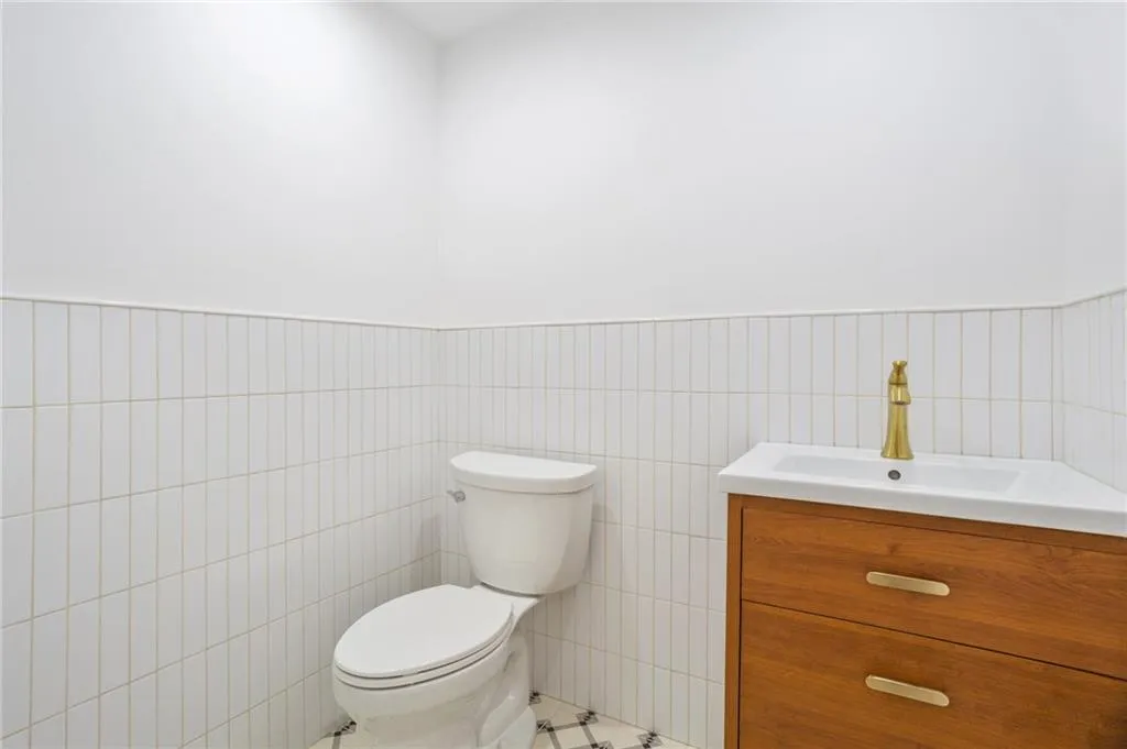 a bathroom with a toilet a sink and mirror