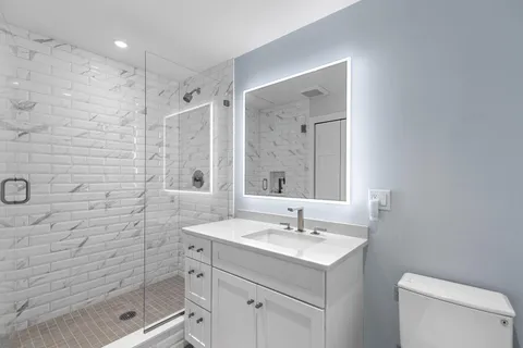 a bathroom with a sink toilet and shower