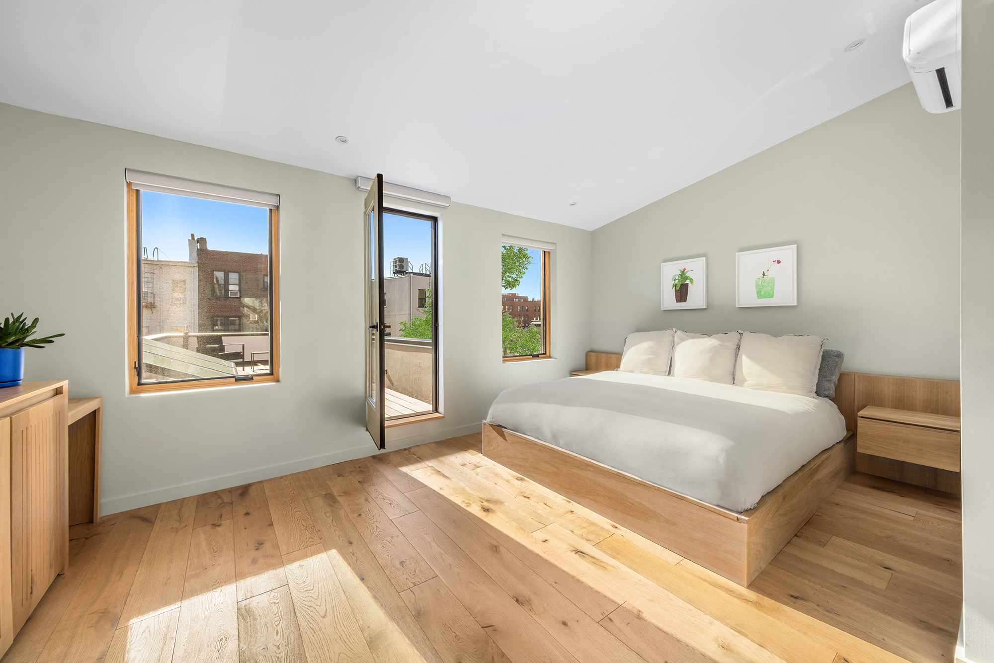 683 Leonard Street Brooklyn, NY 11222 - Photo 17 of 25 a bedroom with a bed and a large window