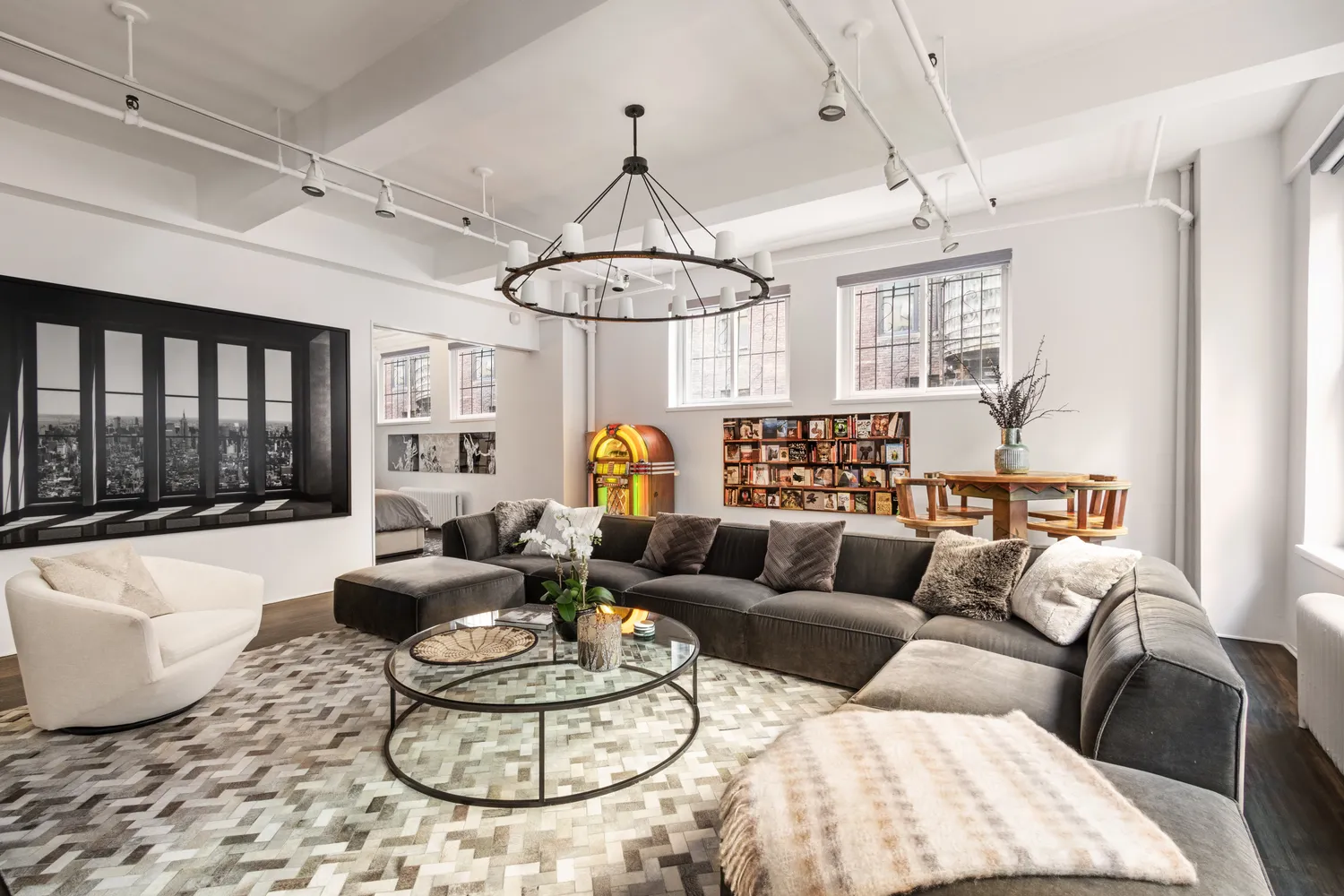 a living room with furniture chandelier and a table