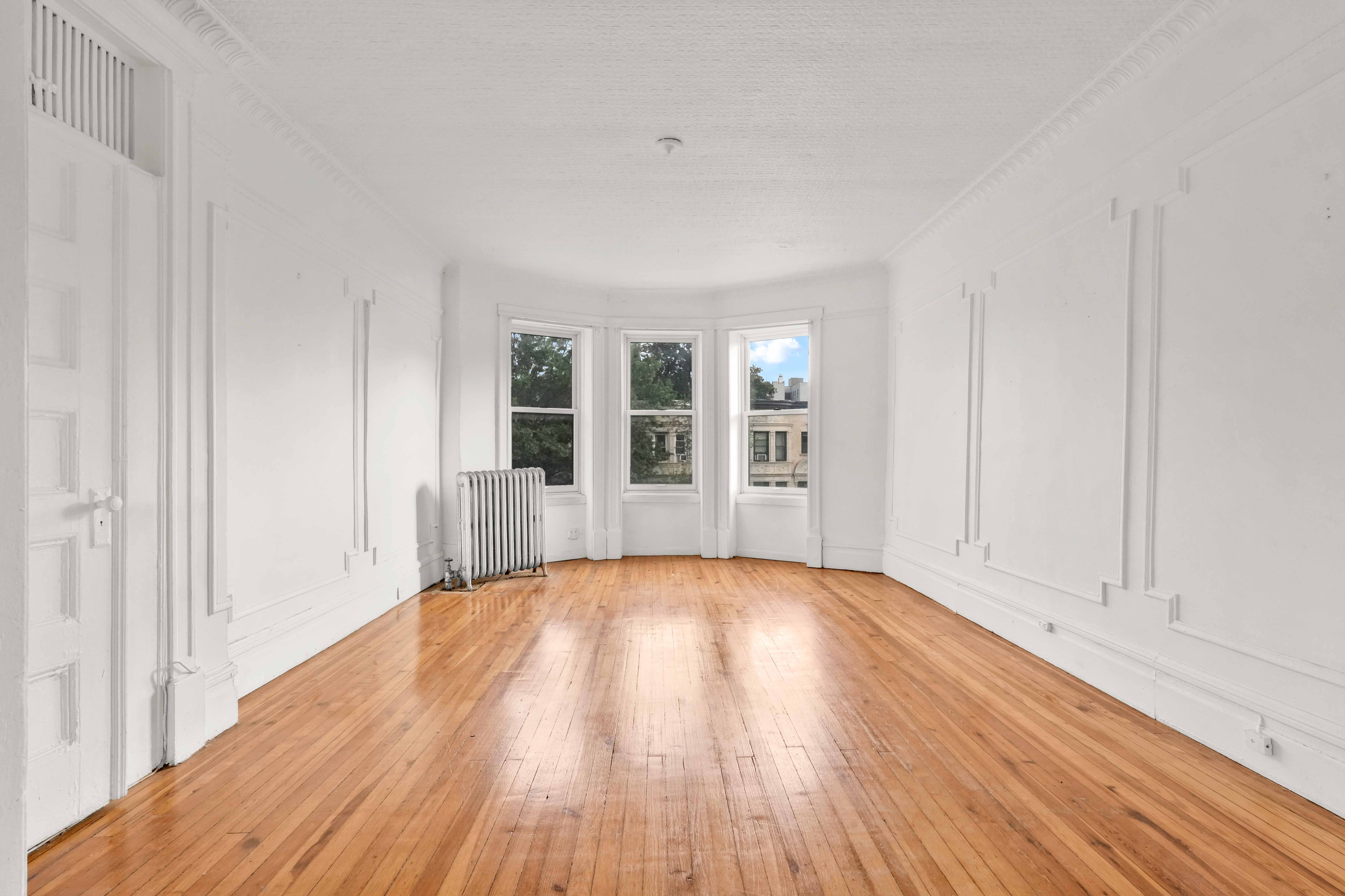 278 Lefferts Avenue Brooklyn, NY 11225 - Photo 4 of 56 a view of empty room with wooden floor and fan