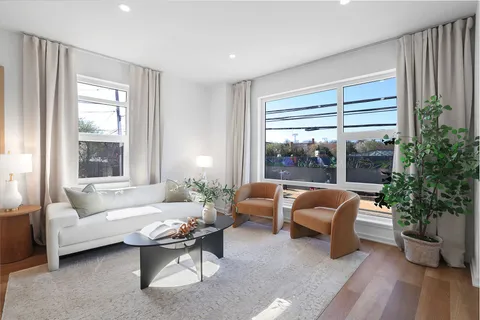 a living room with furniture and a potted plant