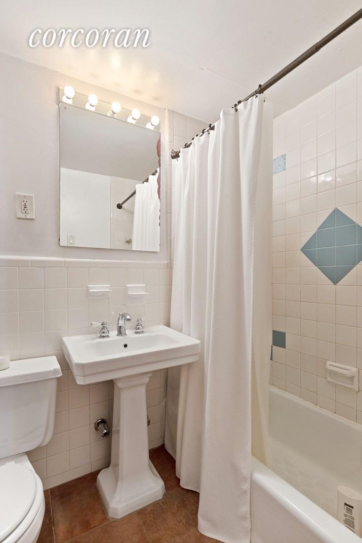 107 West 70th Street, Unit 1F Manhattan, NY 10023 - Photo 3 of 5 a bathroom with a sink toilet and shower