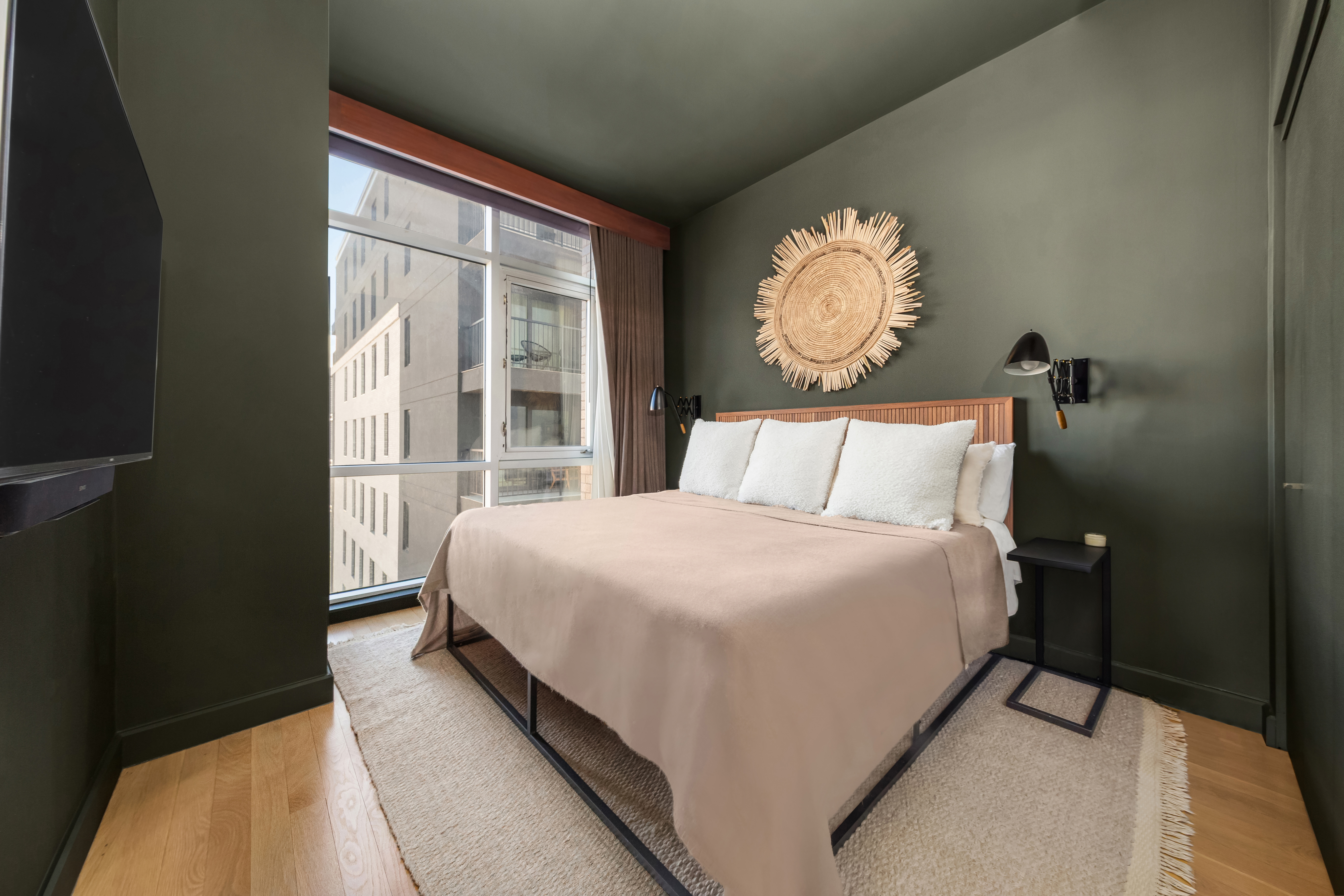 11-24 31st Avenue, Unit 5A Queens, NY 11106 - Photo 5 of 11 a bedroom with a bed and a large window