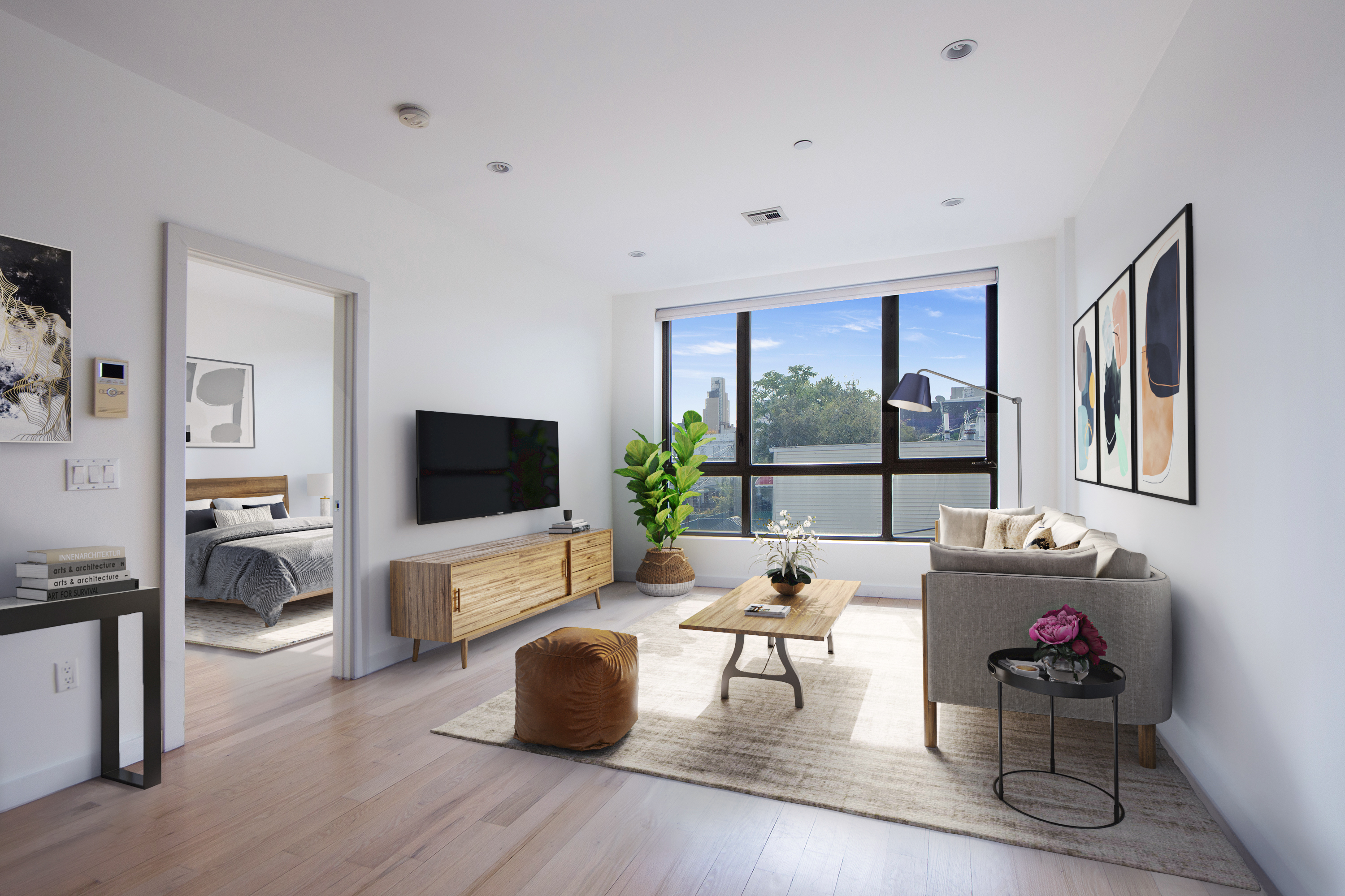 a living room with furniture floor to ceiling window hardwood floor and a flat screen tv