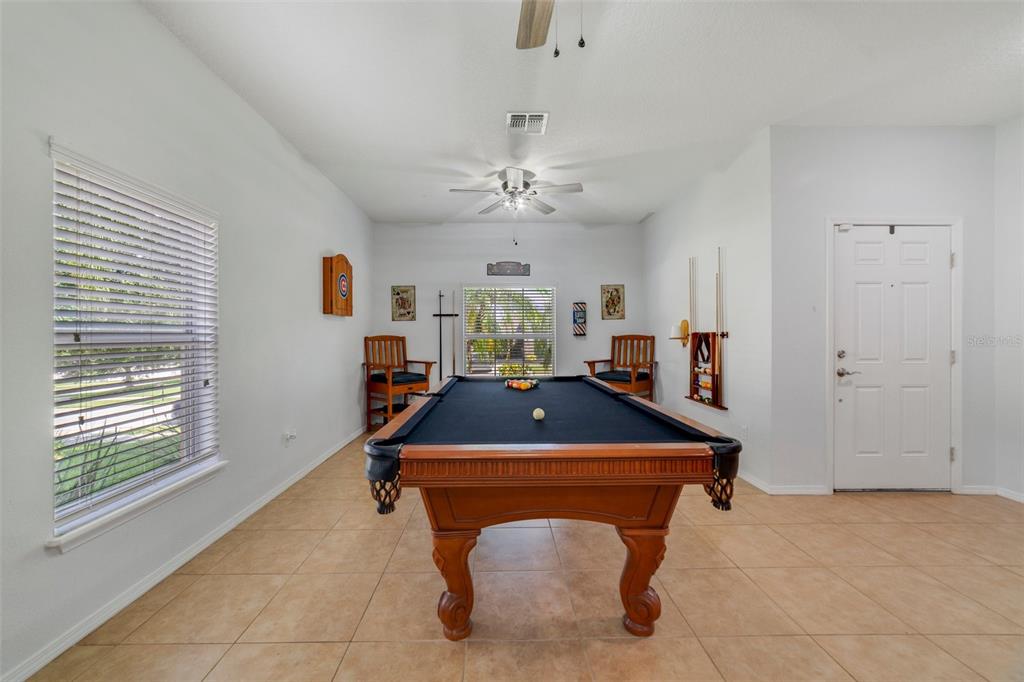 352 Giovani Boulevard Clermont, FL 34715 - Photo 7 of 46 a room with pool table and windows