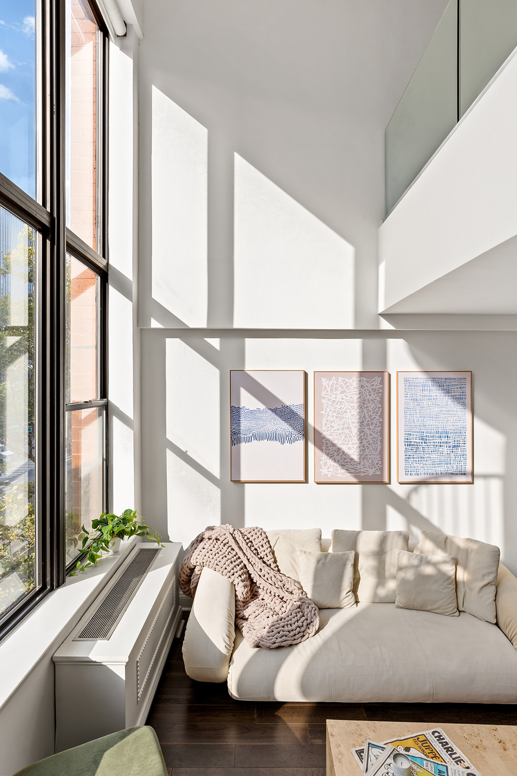65 Cooper Square, Unit 3A Manhattan, NY 10003 - Photo 2 of 7 a living room with furniture and a large window