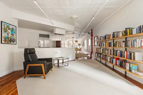a room with furniture and a book shelf