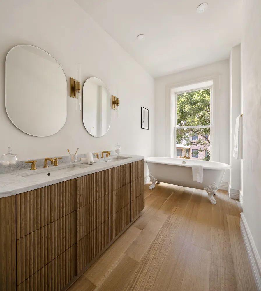 a bathroom with a double vanity sink and a large mirror