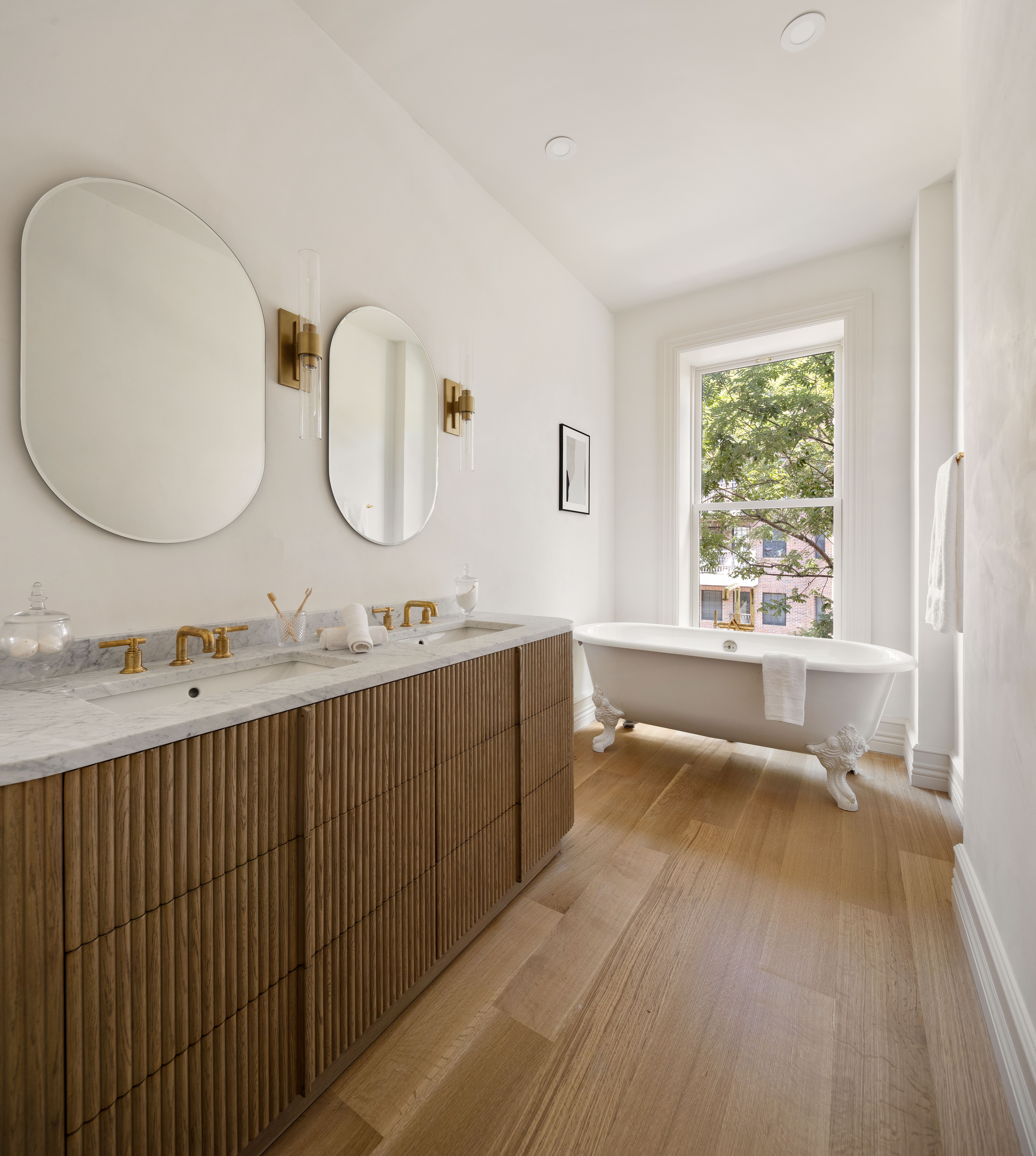 304 West 137th Street Manhattan, NY 10030 - Photo 16 of 26 a bathroom with a double vanity sink and a large mirror